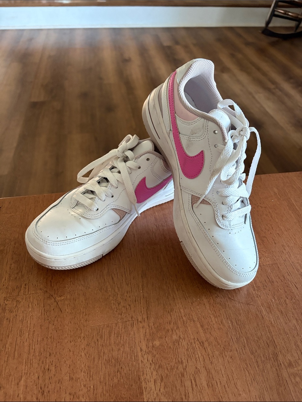 Nike Women’s White Sneakers with Pink Swoosh Accent
